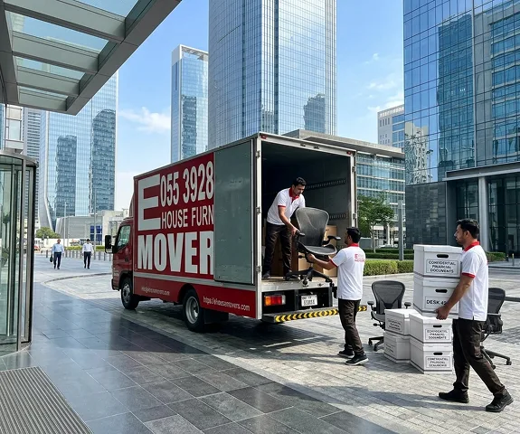 E House Movers crew rebuilding a multi-screen trading desk at a Dubai financial firm