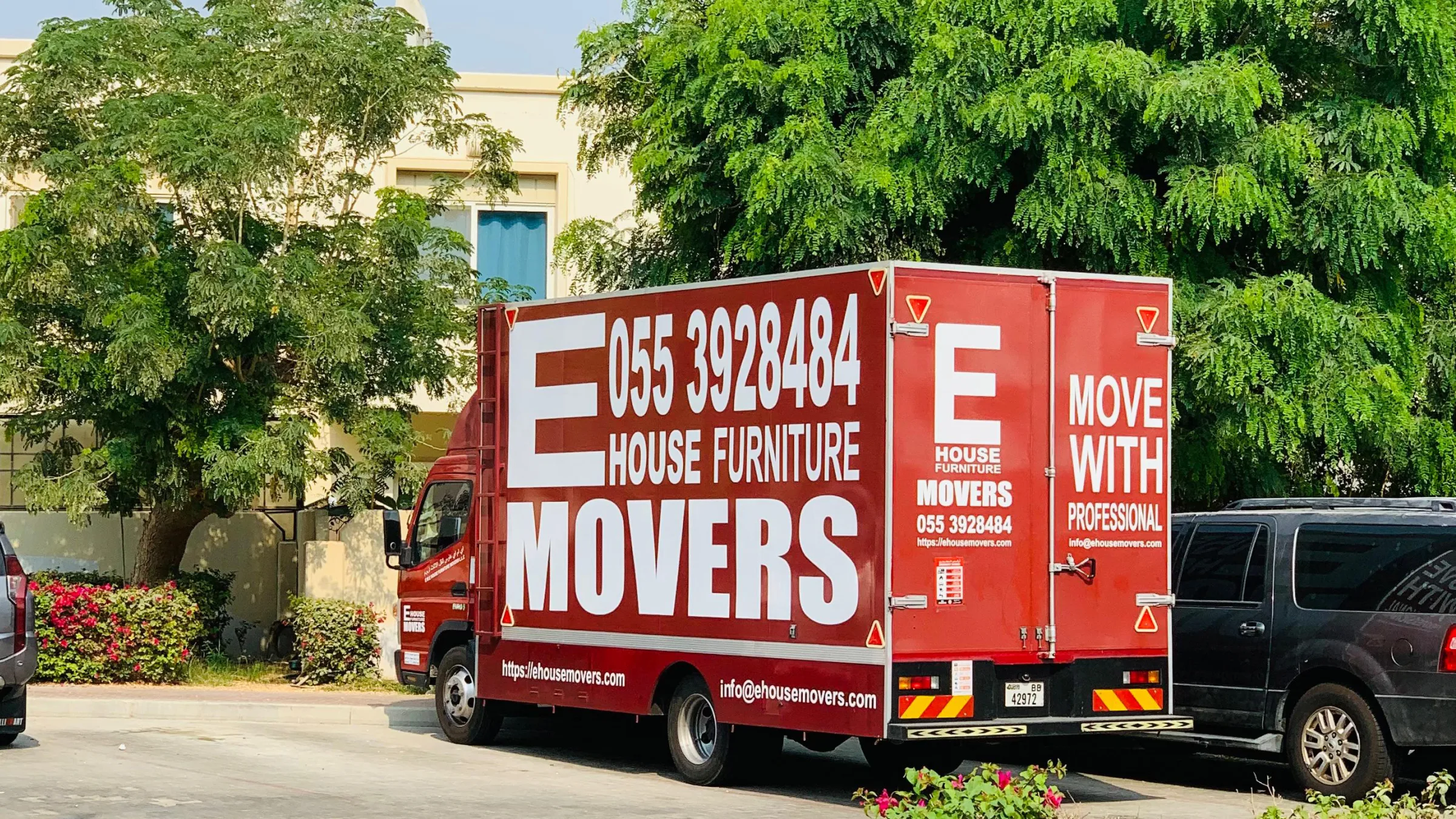 Movers in Dubai - the E House Movers crew loading a GPS-tracked truck