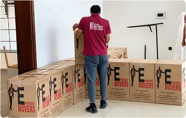 E House Movers staff packing and stacking office boxes during business relocation